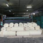 Stock de rouleaux de laine tissés par la Filature Colbert prêts à être exploités